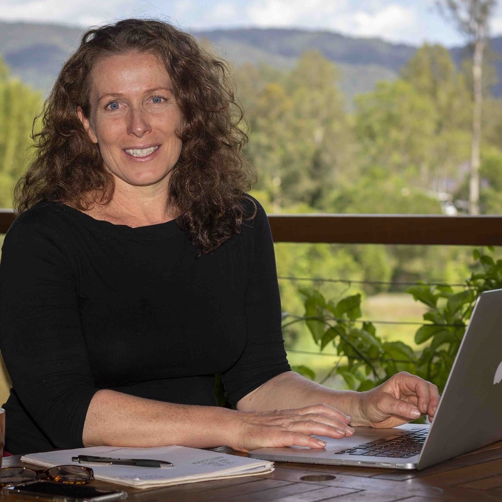 Morag at computer, preparing a free permaculture masterclass