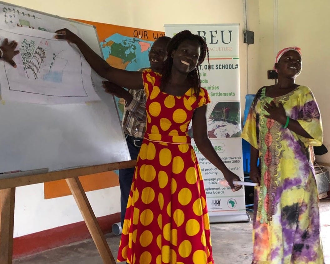 Jenipher in the spotted dress - we sponsored her to attend her PDC in Uganda and supported her permaculture education work since.